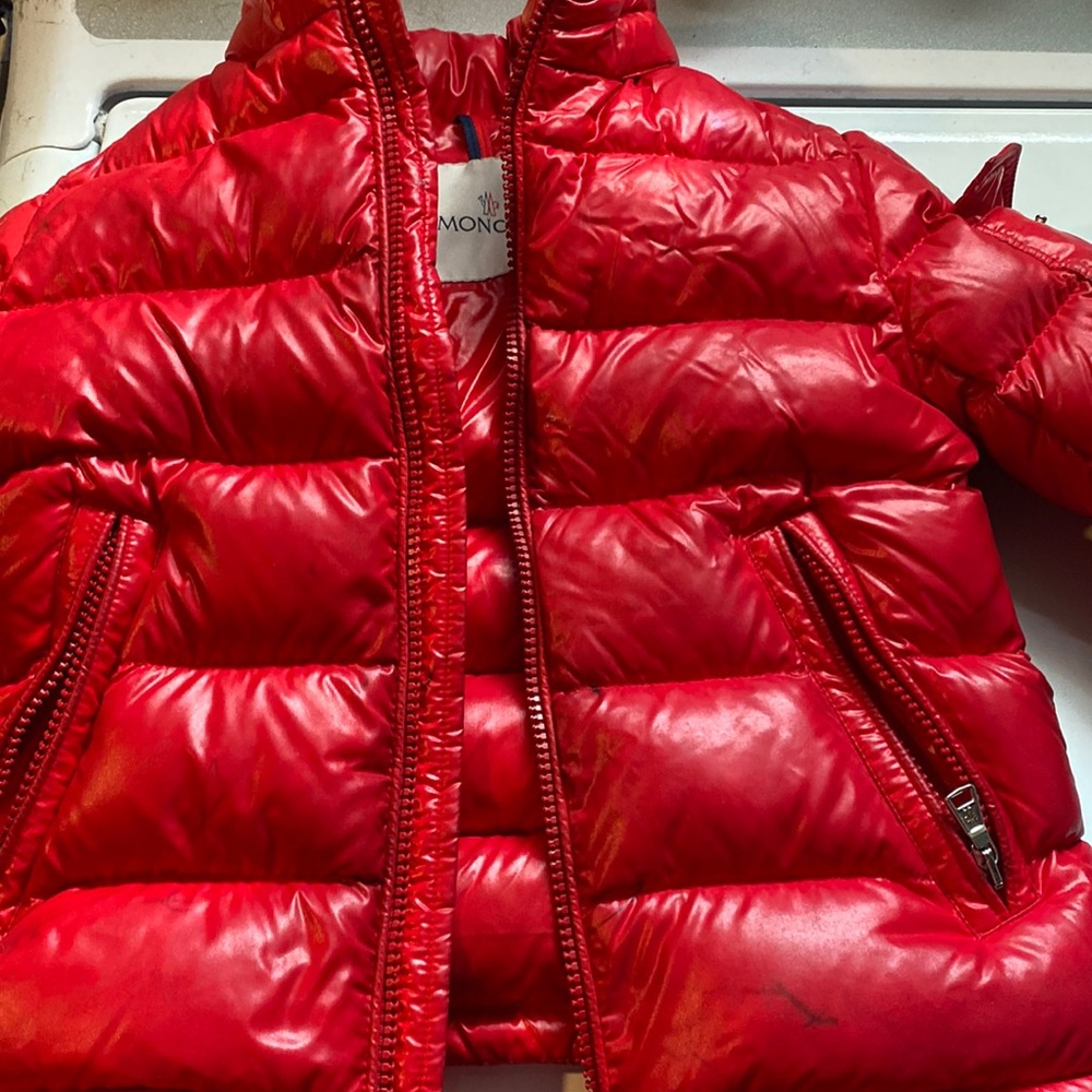Gently used moncler boys size 5A need cleaners and it has a few marker stains